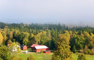 En gård i höstigt landskap.