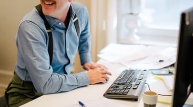 A man sitting at a desk in front of a computer