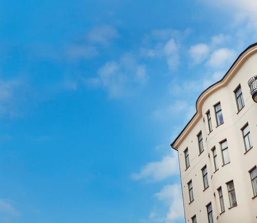 Lägenhetesbyggnad mot en blå himmel