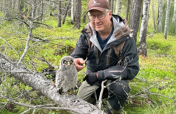 Mats Lundberg i sin skog med en lappuggleunge